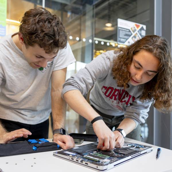 Volunteers fix a laptop at last year’s Bowers CIS Earth Day Repair Fair in Gates Hall. (photo by Noël Heaney)